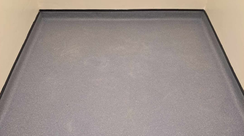Grey safety flooring with welded edges and coved skirting